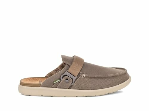 Casual brown slip-on shoe with strap.