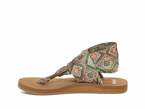 Side view of a colorful patterned sandal with a flat sole.