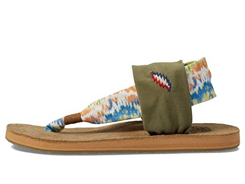 Side view of a sandal with colorful fabric strap and embroidered detail