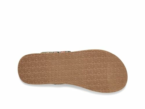 Bottom view of a sandal showing its rubber sole with a textured pattern.